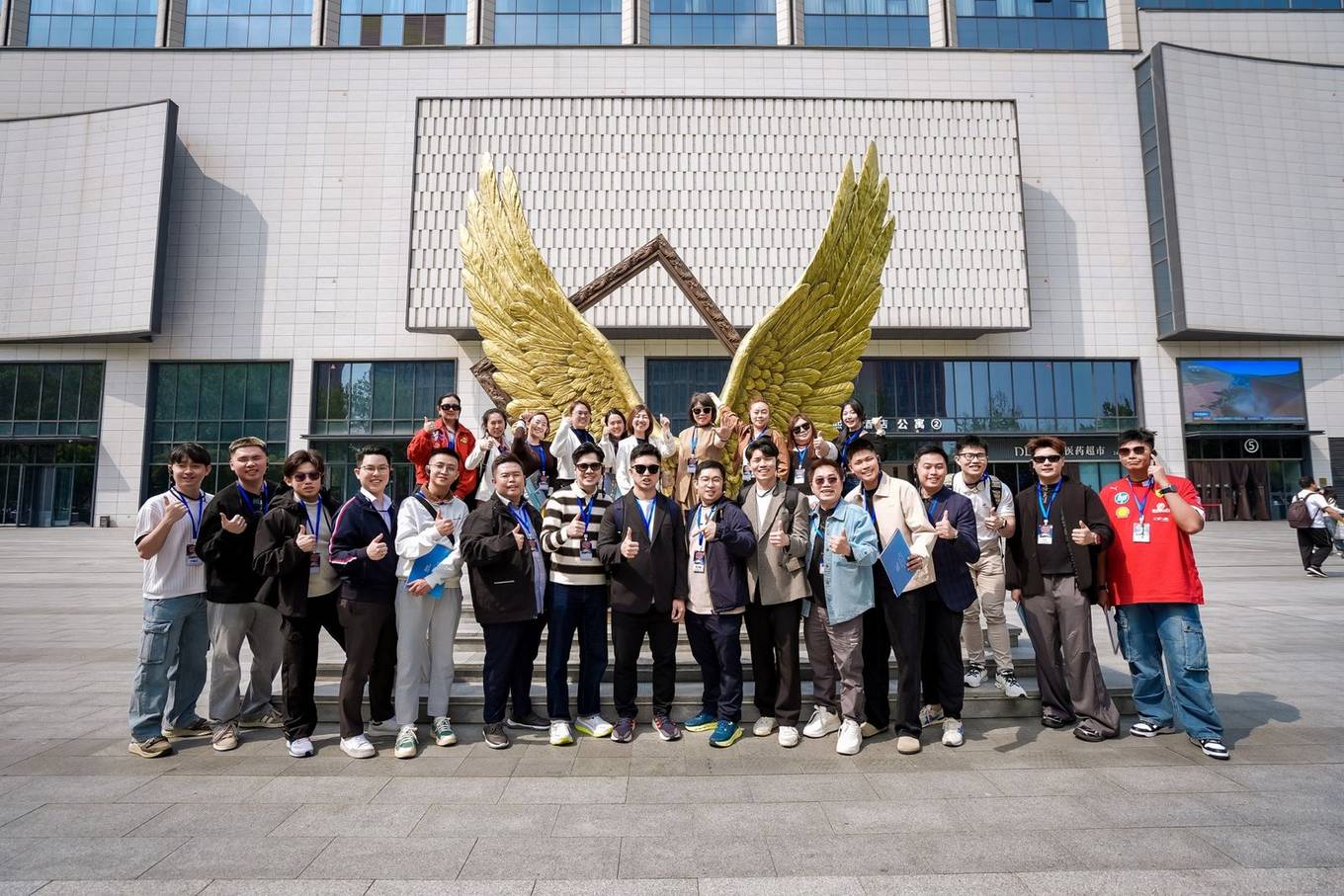 Delegates at the golden wings sculpture